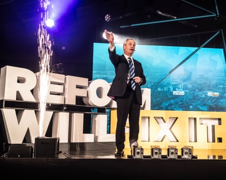 Nigel Farage on a stage in front of a sign that says ‘Reform will fix it’