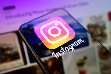 A smartphone displays the Instagram app icon and logo on its screen