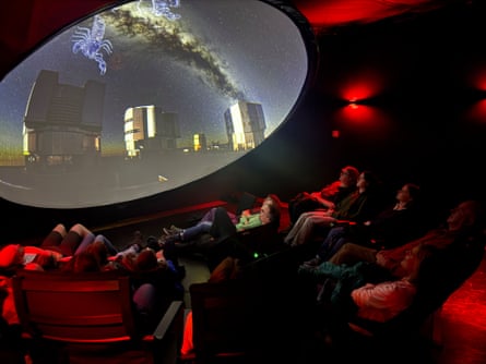 People inside a planetarium watching a constellation show