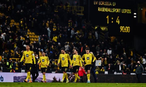 Dortmund players trudge off at full-time as fans make their way to the exits following their 4-1 home defeat.