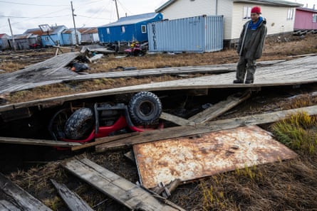 A man standing on a boardwalk.