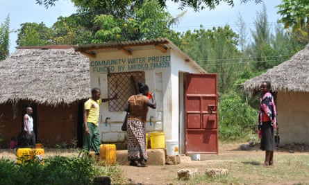 A woman drinks water at Makongeni village’s water point, which was funded by Mikoko Pamoja’s proceeds from trading carbon.