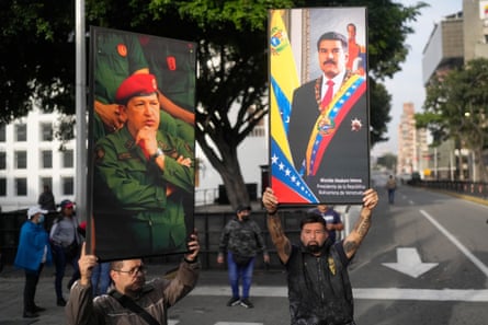 Government supporters display posters of Nicolás Maduro, right, and the late president Hugo Chávez in Caracas, Venezuela, on 3 January.