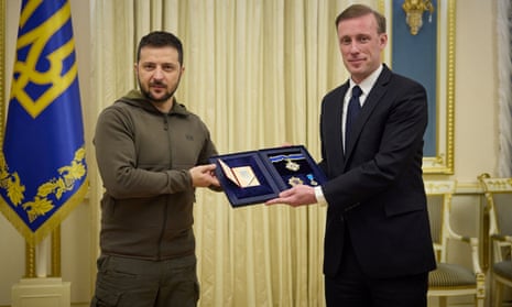 Ukraine's President Volodymyr Zelenskiy (left) gives an award to U.S. White House National Security Advisor Jake Sullivan, last Friday.