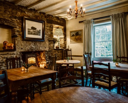 Inside the Hare and Hounds pub with original beams stone walls and fireplace