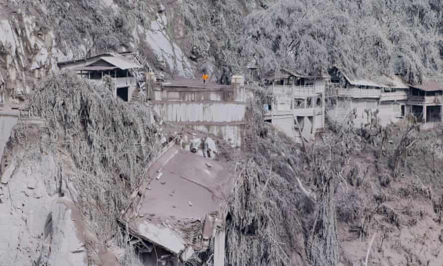 Ash covers houses and trees on the slopes of Mount Semeru in Lumajang, East Java, the day after Saturday’s eruption.