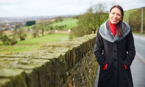 Debbie Abrahams standing outside by a stone wall