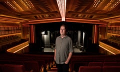 Nick Stabback standing in one of the aisles in the seats of the Enmore Theatre