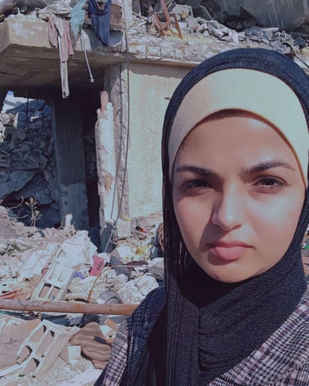 Photo showing Aya Talb in front of the ruins of her home