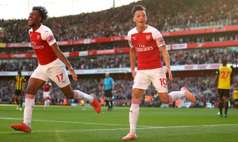 Mesut Özil celebrates scoring Arsenal’s second goal against Watford with Alex Iwobi.
