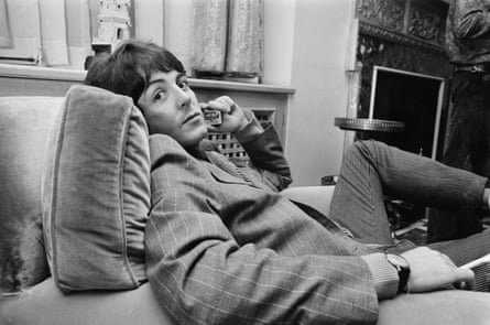 paul mccartney lounges in chair in 1967 black and white image