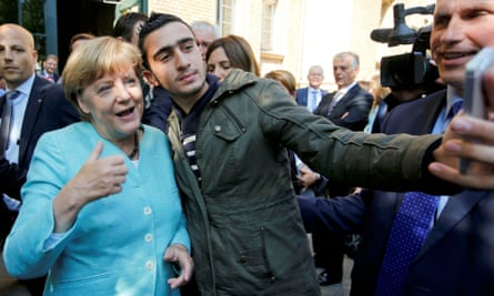 A Syrian refugee takes a selfie with Angela Merkel in Berlin in 2015.
