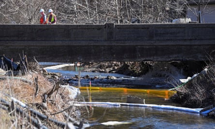 People clean up the site following the derailment of a train carrying hazardous waste in East Palestine, Ohio.