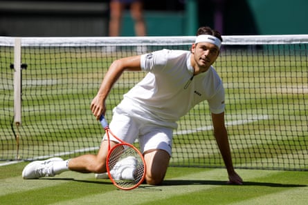 Taylor Fritz gets up off the grass on Centre Court