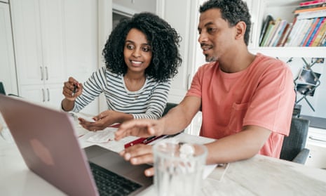 Couple and their financial planning in the kitchen with laptop