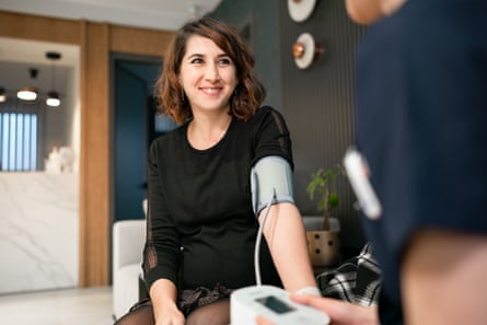 woman having blood pressure measured