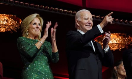 Joe Biden points a finger and the first lady, Jill Biden, applauds