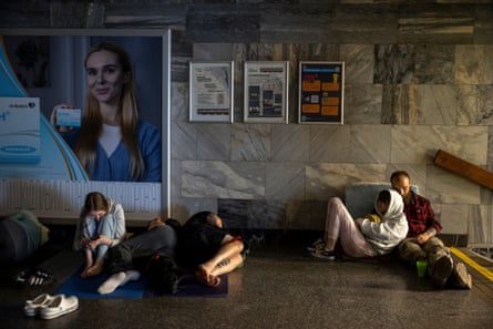 People take shelter in a metro station during a Russian drone and missile attack on Kyiv.