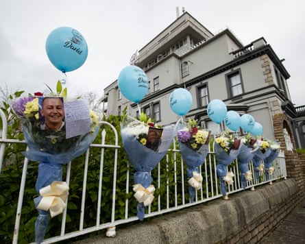 Bouquets and photographs of victim David Bryne displayed outside a building where he was killed