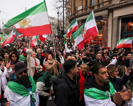People wave the Lion and the sun flag on Whitehall, London