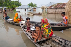 People row through the flood-hit area