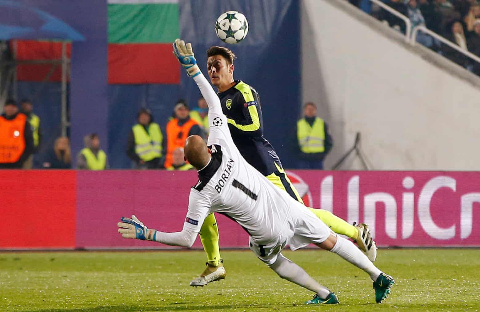 Mesut Ozil lobs goalkeeper Milan Borjan.