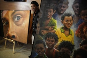 Rio de Janeiro, BrazilRetired footballer Ronaldinho Gaucho poses beside a painting of him by Brazilian artist Emerson Carvalho de Souza, known as Camelao at the Maracana stadium.