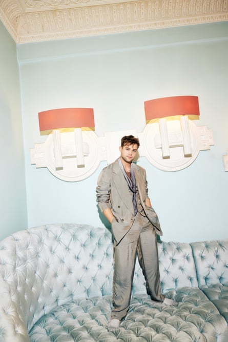 Leo’s star is rising: Leo Woodall wears satin suit and scarf, all Giorgio Armani (armani.com) andgold chain by heyharper.com.