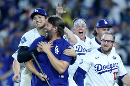 Clayton Kershaw, Shohei Ohtani and Max Muncy of the Los Angeles Dodgers celebrate on the field after Monday’s win.