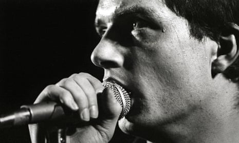 Ian Curtis performing with Joy Division.