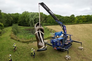 A crane lifts an almost seven-metre-high Henry Moore sculpture