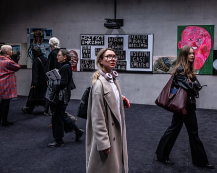A woman views works of art on display at Art Collect, a contemporary art fair held at the International Conference Centre