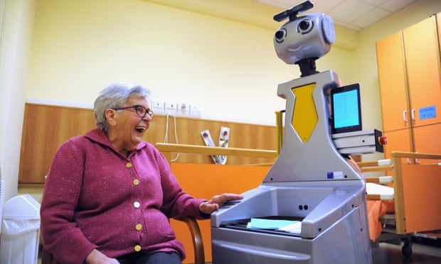A woman at a nursing home in San Lorenzo, Italy, talks to Robot-Era