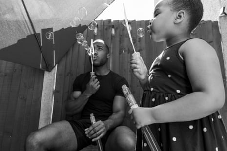 Jordan and his daughter Callie blowing bubbles on a hot summer’s day in the garden