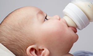 A baby being fed from a bottle