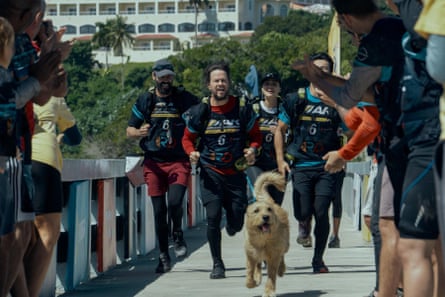 A group of people running a marathon with a dog leading the way