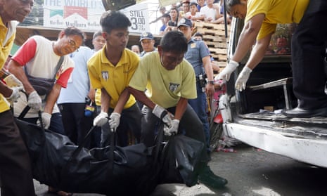 The body of man suspected of drug dealing is removed from a street in Manila after a police operation in November 2016.