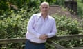 Iain Dale leaning against a wooden fence