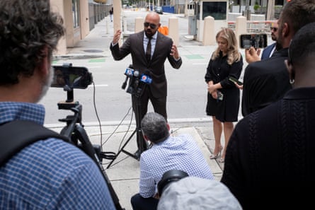 a man speaks into microphones