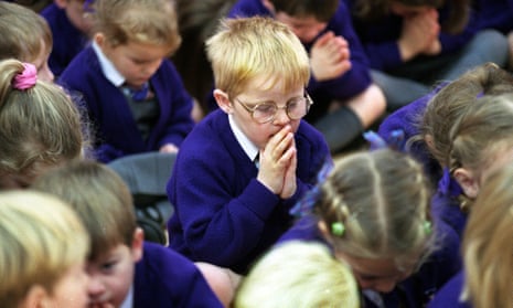 Children praying in assembly at a traditional Christian school