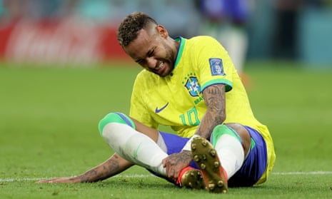 Neymar clutches his ankle after a challenge from Serbia’s Nikola Milenkovic