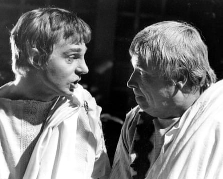 A black and white shot of the two men standing close together talking