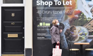 a masked man passes a shop to let in London
