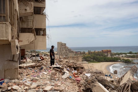 A rescue worker surveys the rubble in an area affected by the earthquake in Catia La Mar.