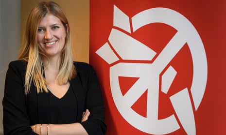 Beatrice Fihn, the executive director of the International Campaign to Abolish Nuclear Weapons poses next to the Ican logo