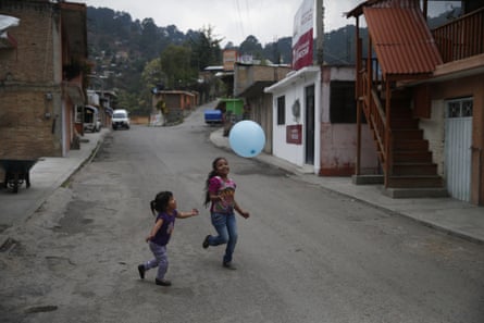 Girls play with a balloon on the quiet main street in Filo de Caballos.