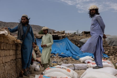 Men stand in the ruins of their houses in Paktika, where a 5.9-magnitude earthquake destroyed at least 35 villages, in June 2022.