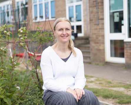 Macci Dobie, head teacher at St John’s CofE primary, sits outside a building.