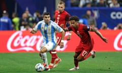 Argentina’s Marcos Acuna, left, fights for the ball with Canada's Alistair Johnston and Tajon Buchanan in pursuit during the first half of Thursday’s match.