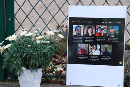 A pot plant next to photos of the seven aid workers.